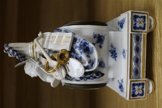 A late 19th century Meissen eight day mantel clock, surmounted by a cherub and objects emblematic of the arts